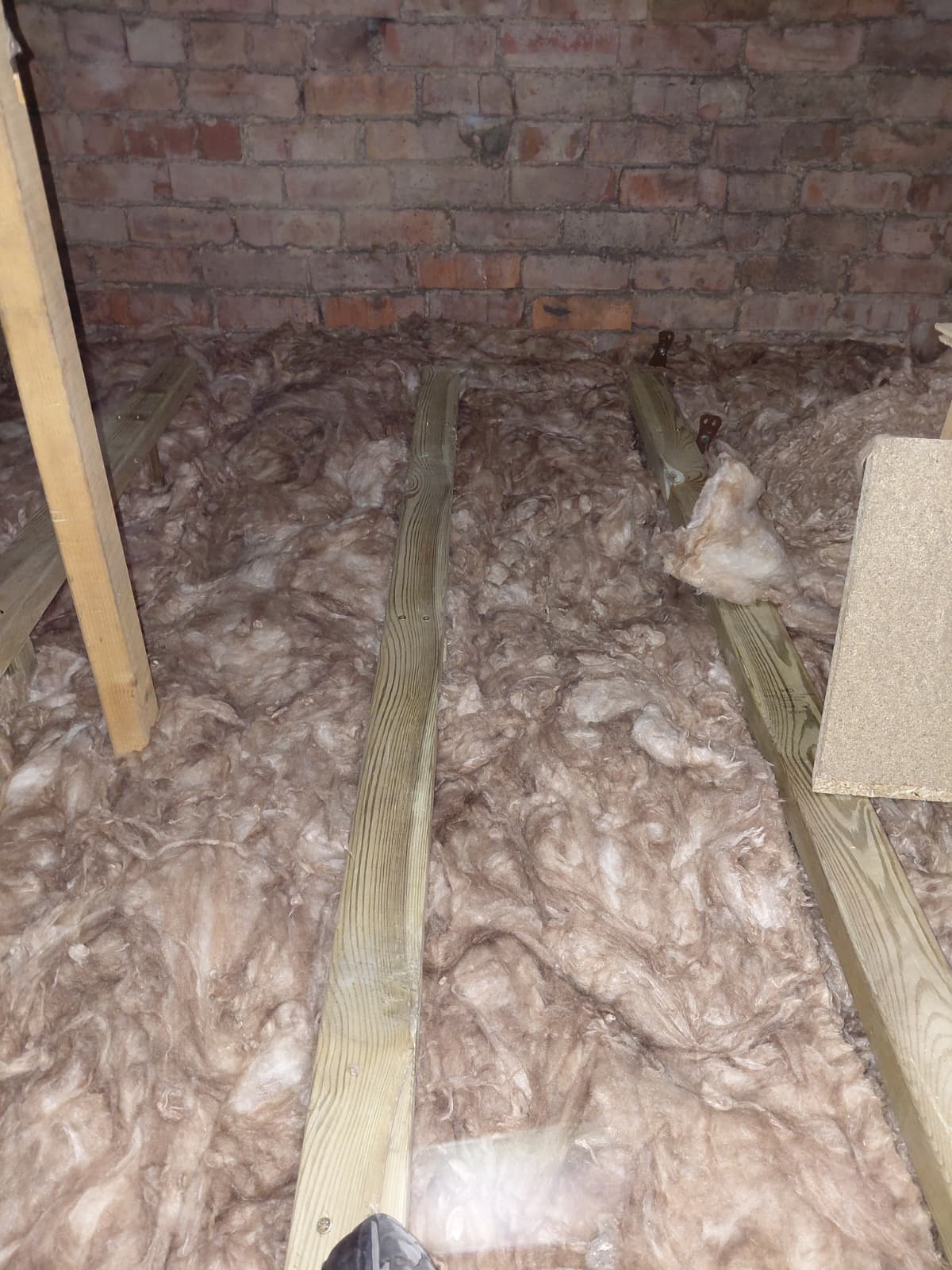 Mineral wool over joists with raised boarding battens ready