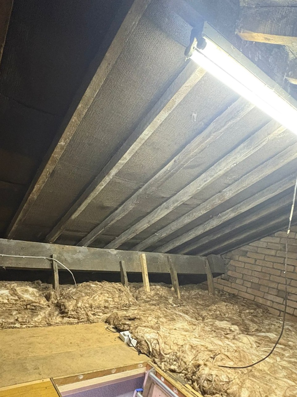 Loft insulation work showing heat loss prevention